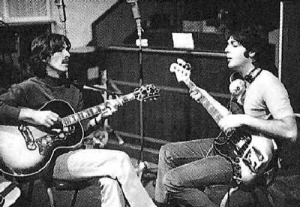 George Harrison, left, and Paul McCartney hammer out a song.